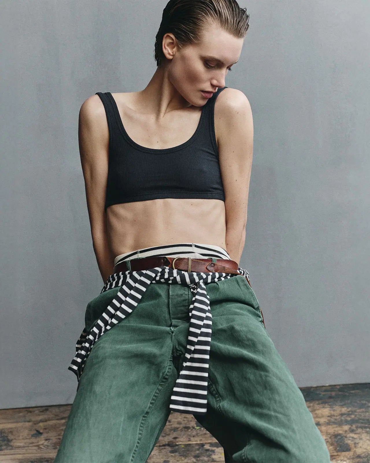 Woman wearing a black ribbed organic cotton bra, breton stripe and a pair of jeans — Hemen Biarritz