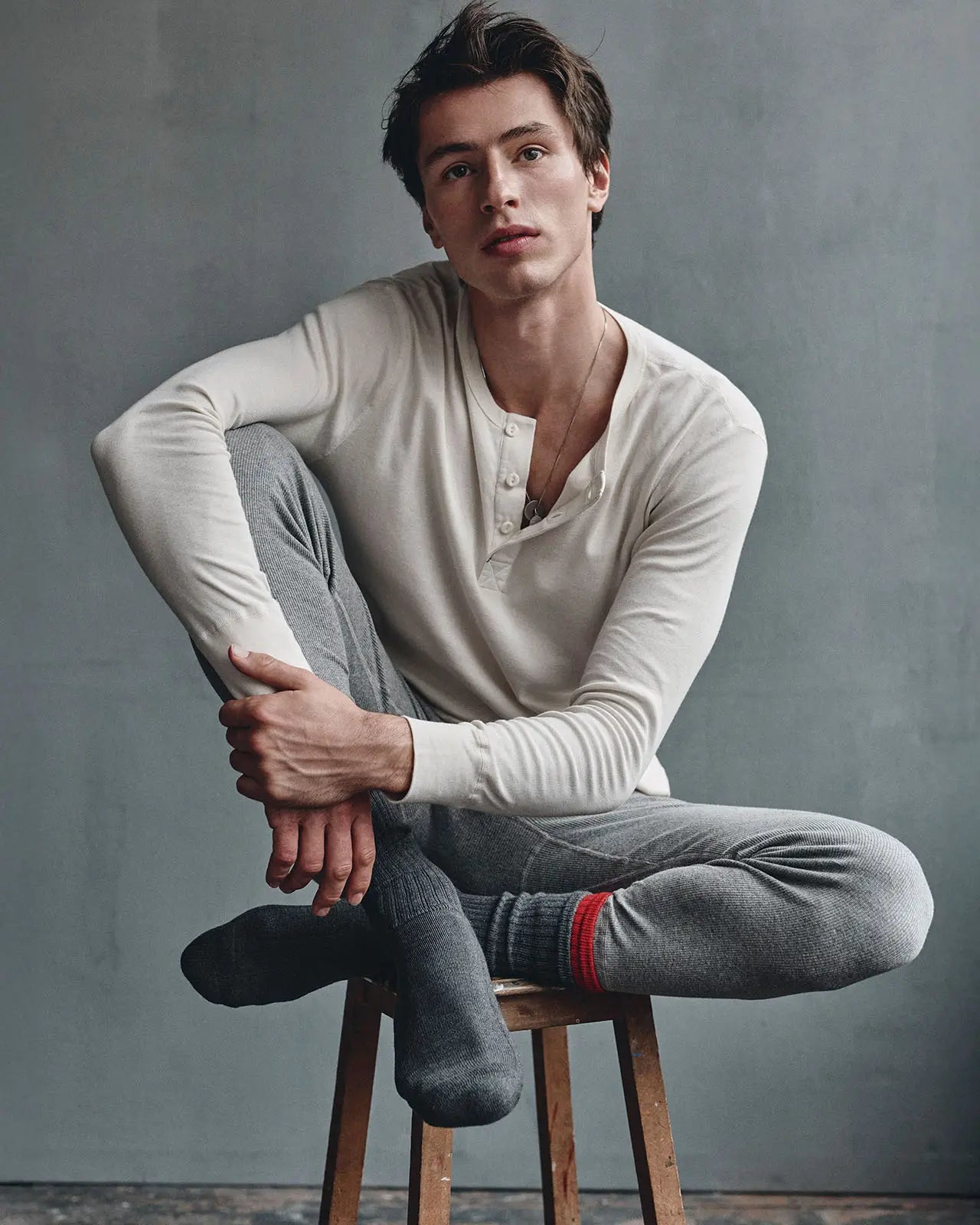 Men's henley longsleeve | Man wearing a long-sleeve Henley shirt in stone organic cotton, signature button-placket detail  | HEMEN Biarritz | henley